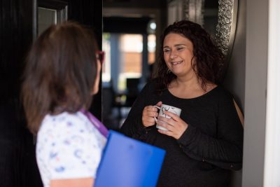 talk to a customer on their doorstep