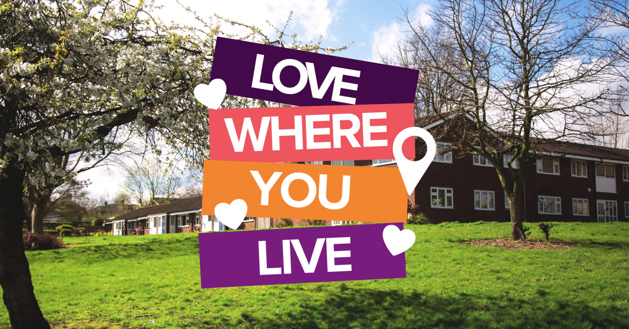 Love where you live logo with a picture of grass, some trees and houses in the background.