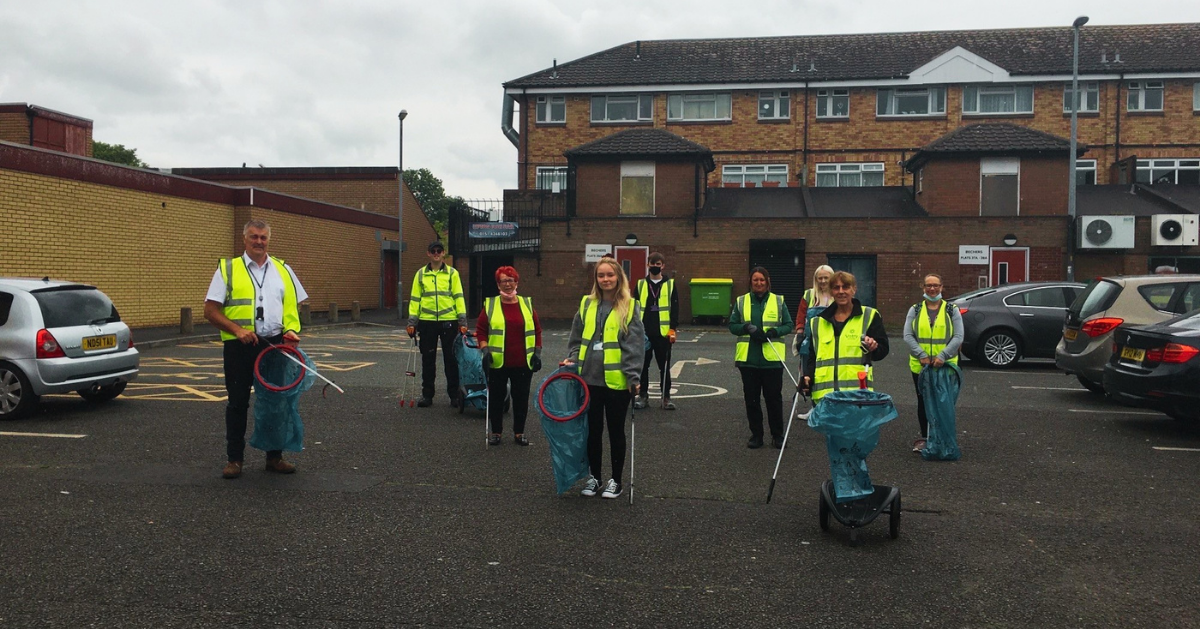 Volunteers stood in high-vis jackets with bin bags for litter picking.