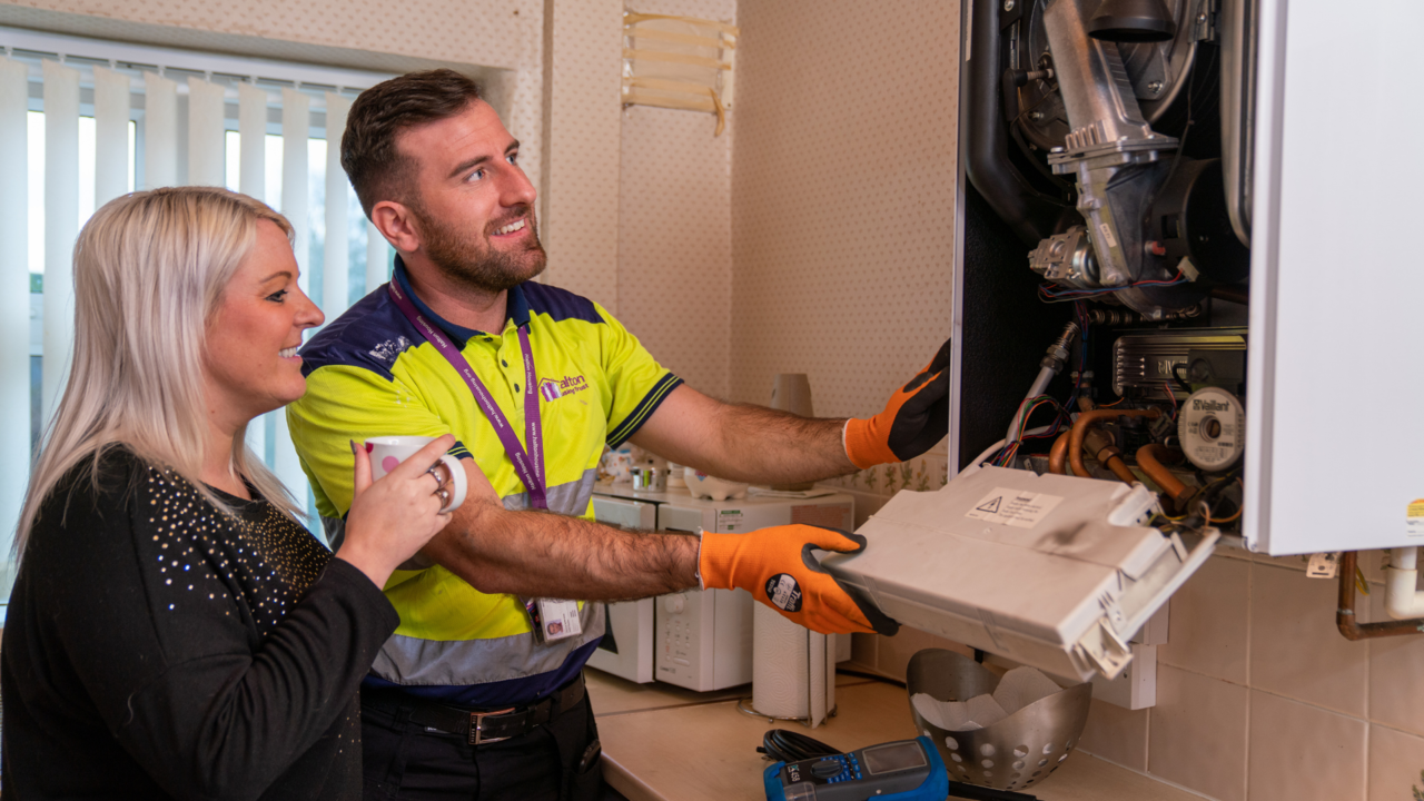 A Halton Housing Gas Engineer fixing a customers boiler
